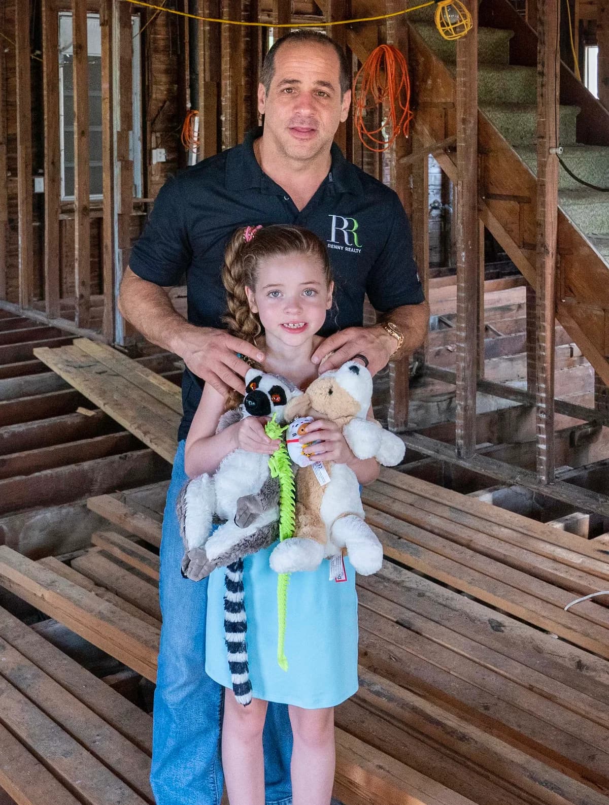 Gus Renny with his daughter inside a home mid-renovation